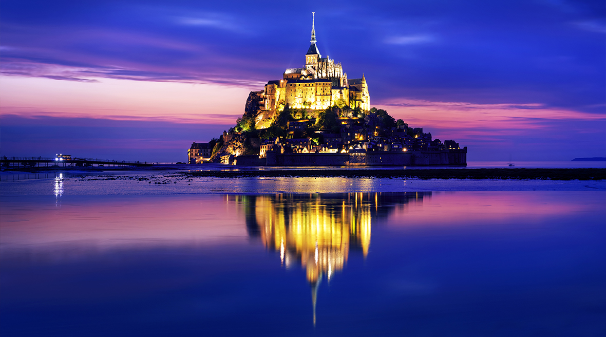 View of Le Mont Saint-Michel island illuminated at dusk